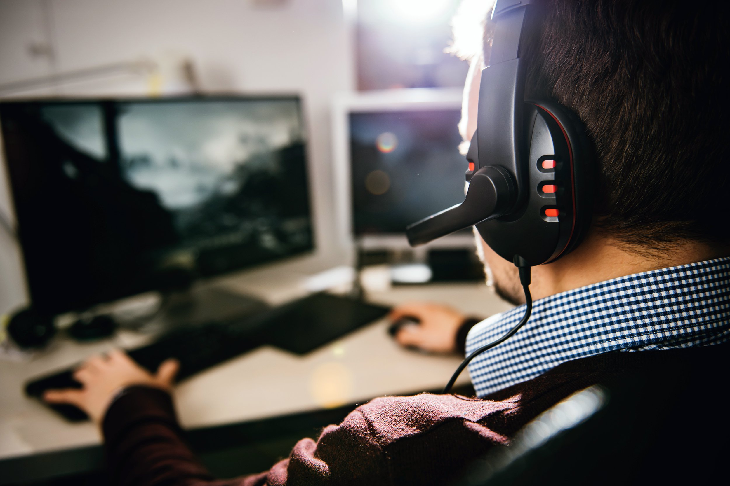 man playing video game on computer