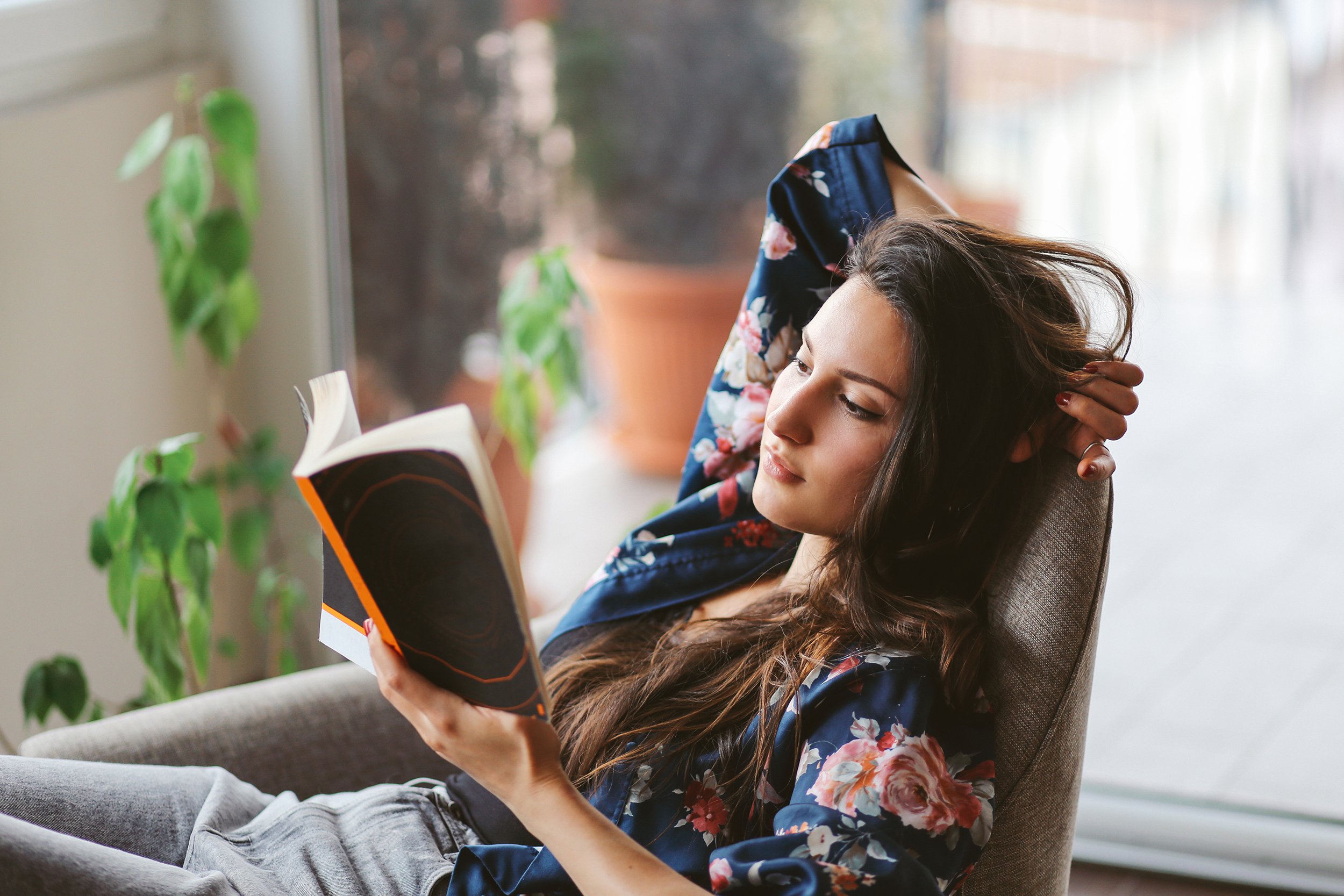young woman reading at home