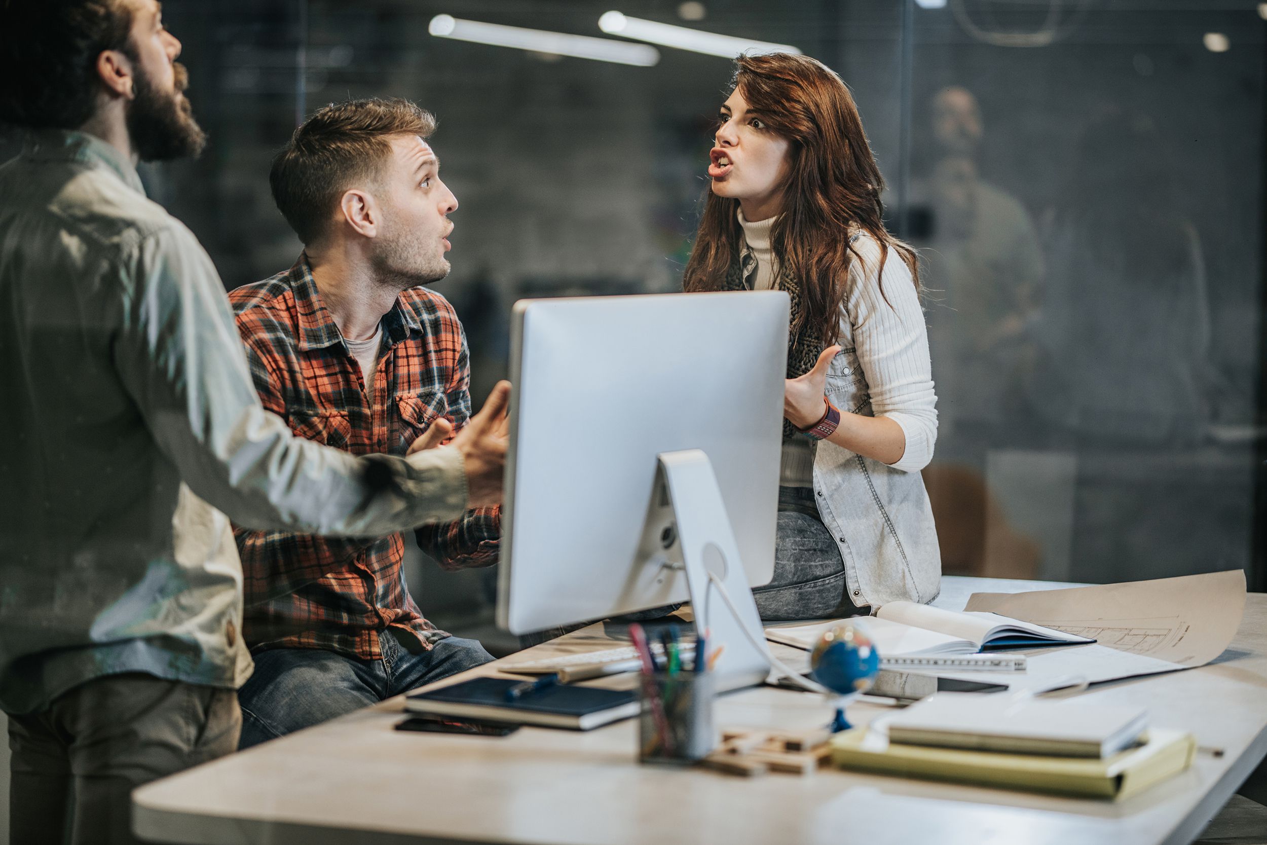 angry colleagues arguing while working in the office