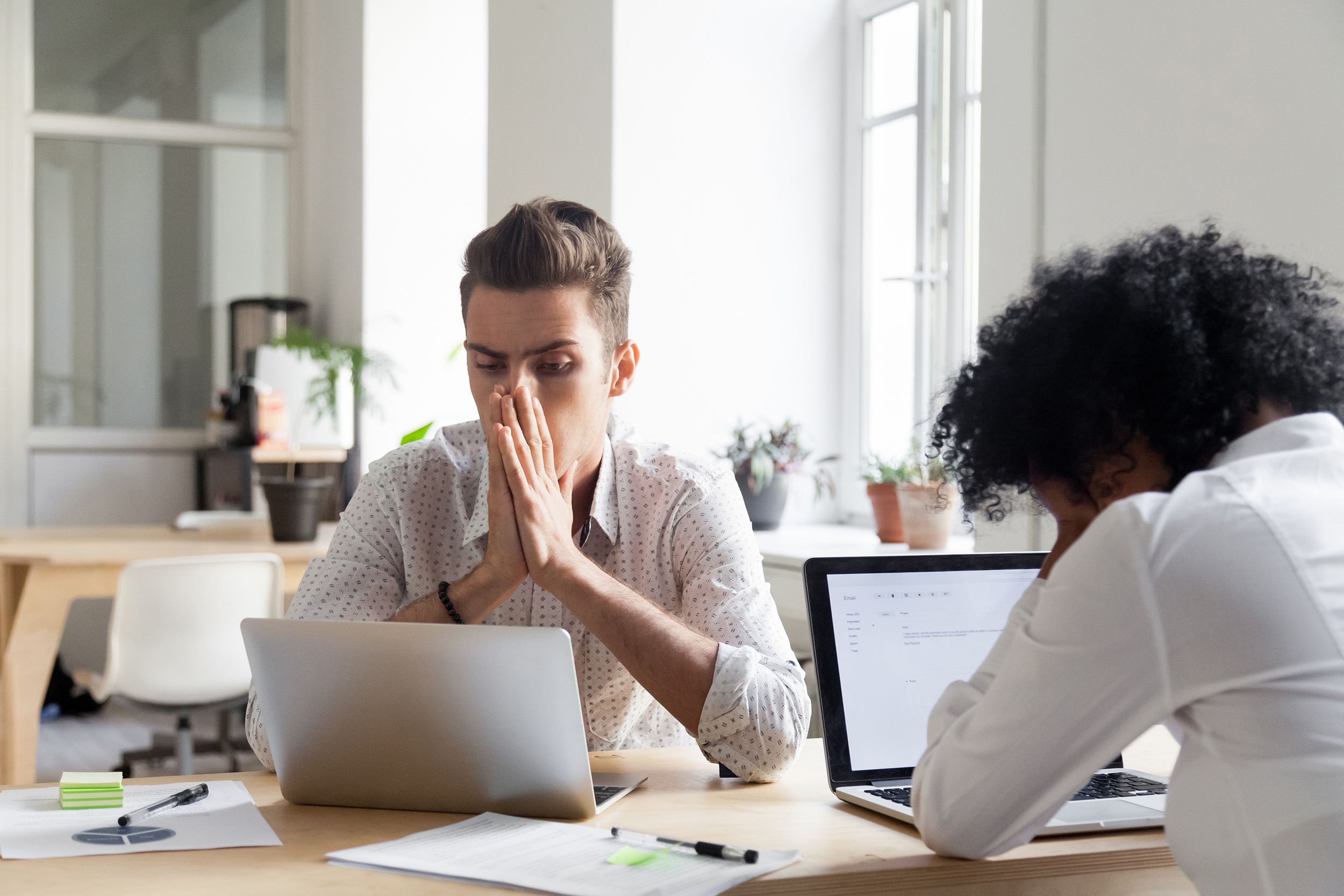 stressed workers reading company bankruptcy news online