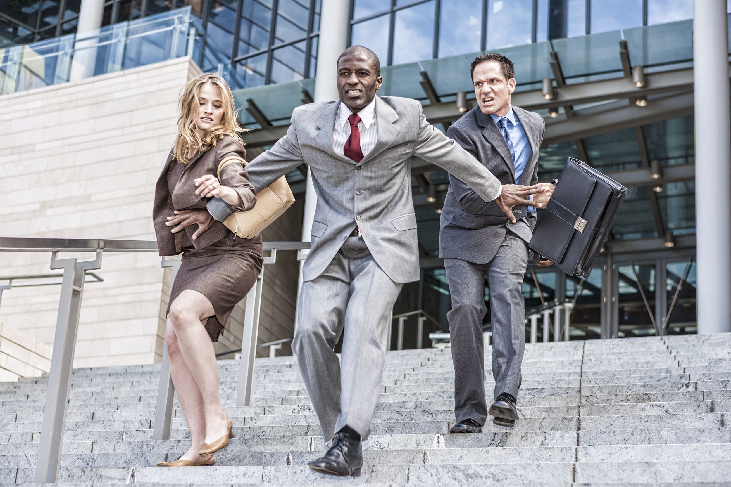 three business people racing to see who will be first