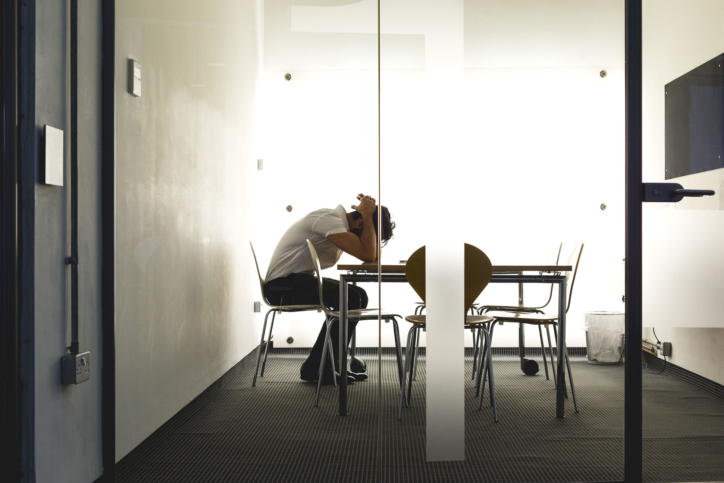 man sitting alone isolated in the an office room
