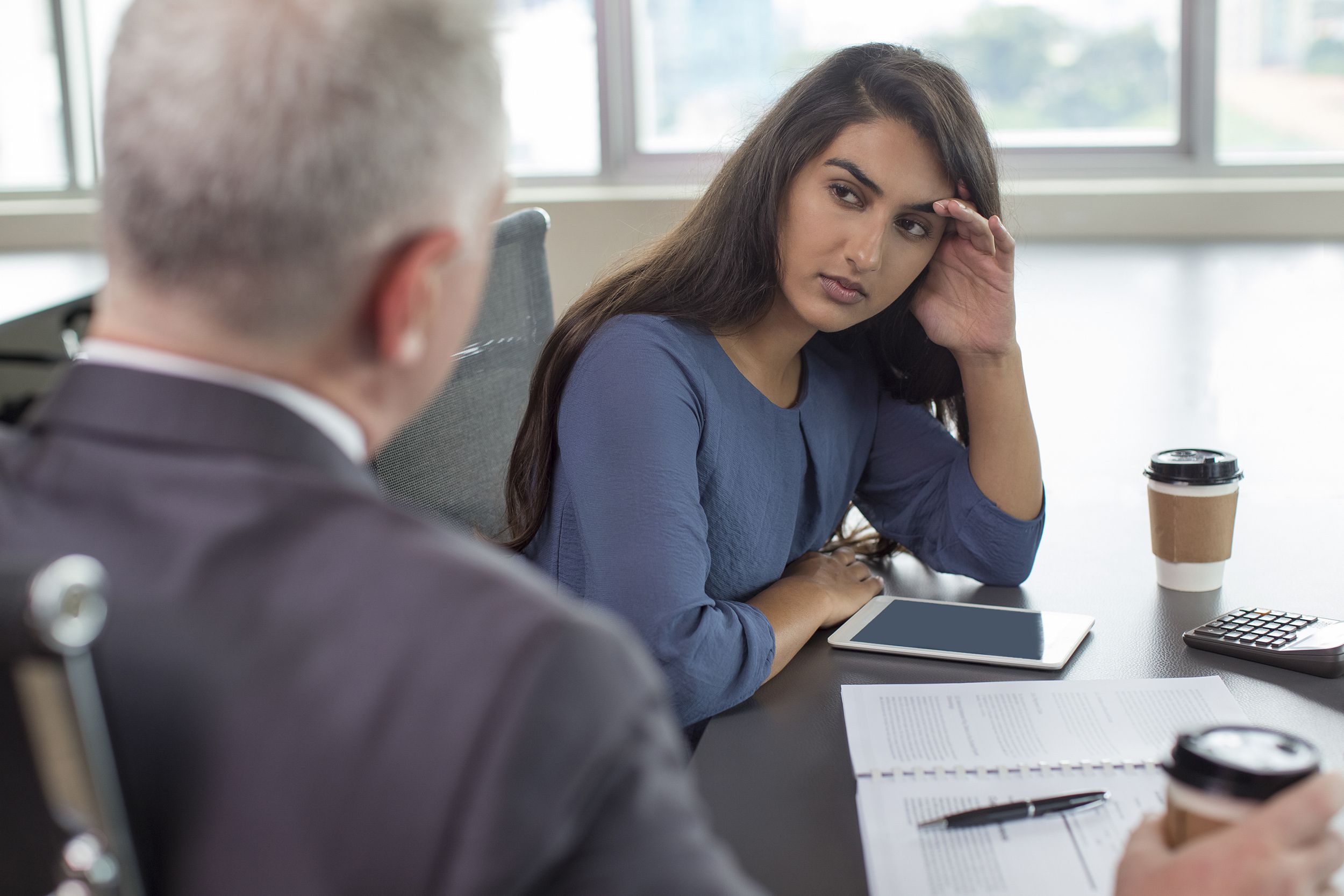 business leader instructing serious Indian female assistant