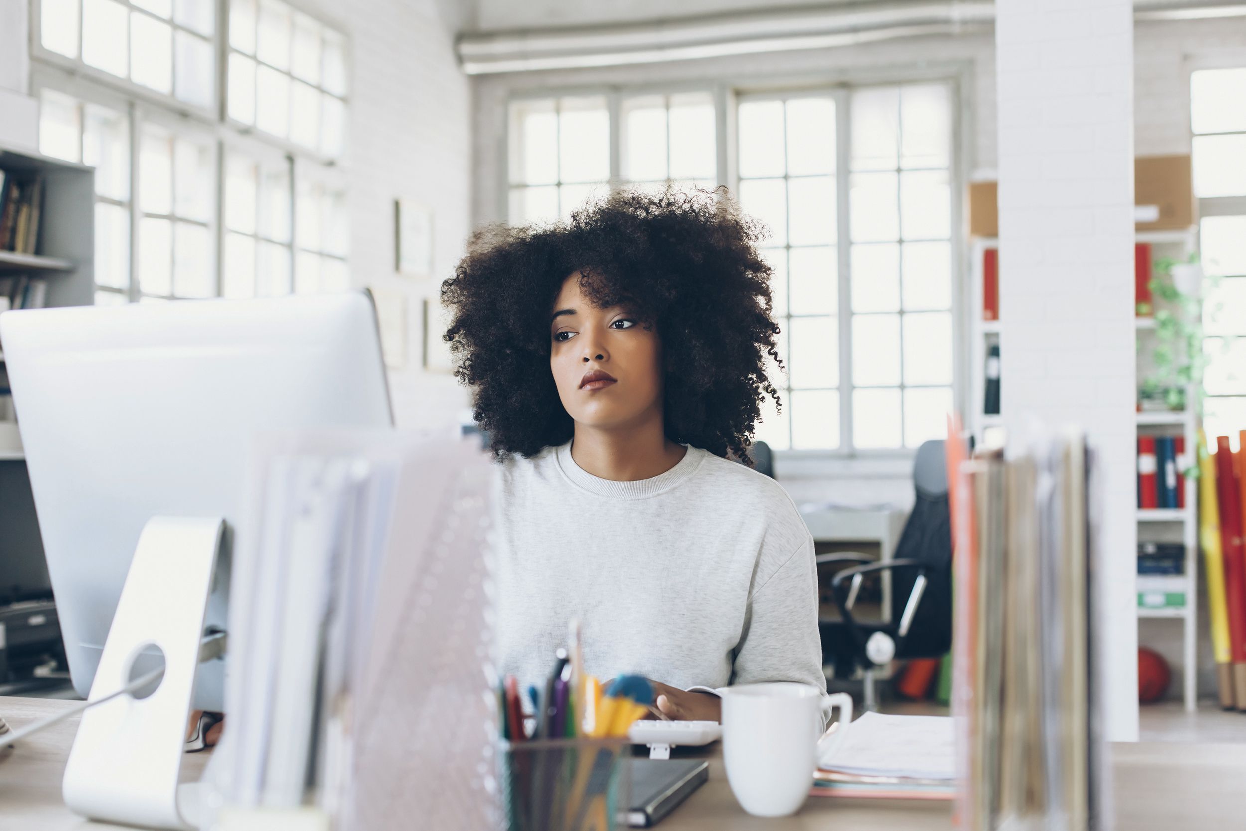 depressed young woman using computer at the office