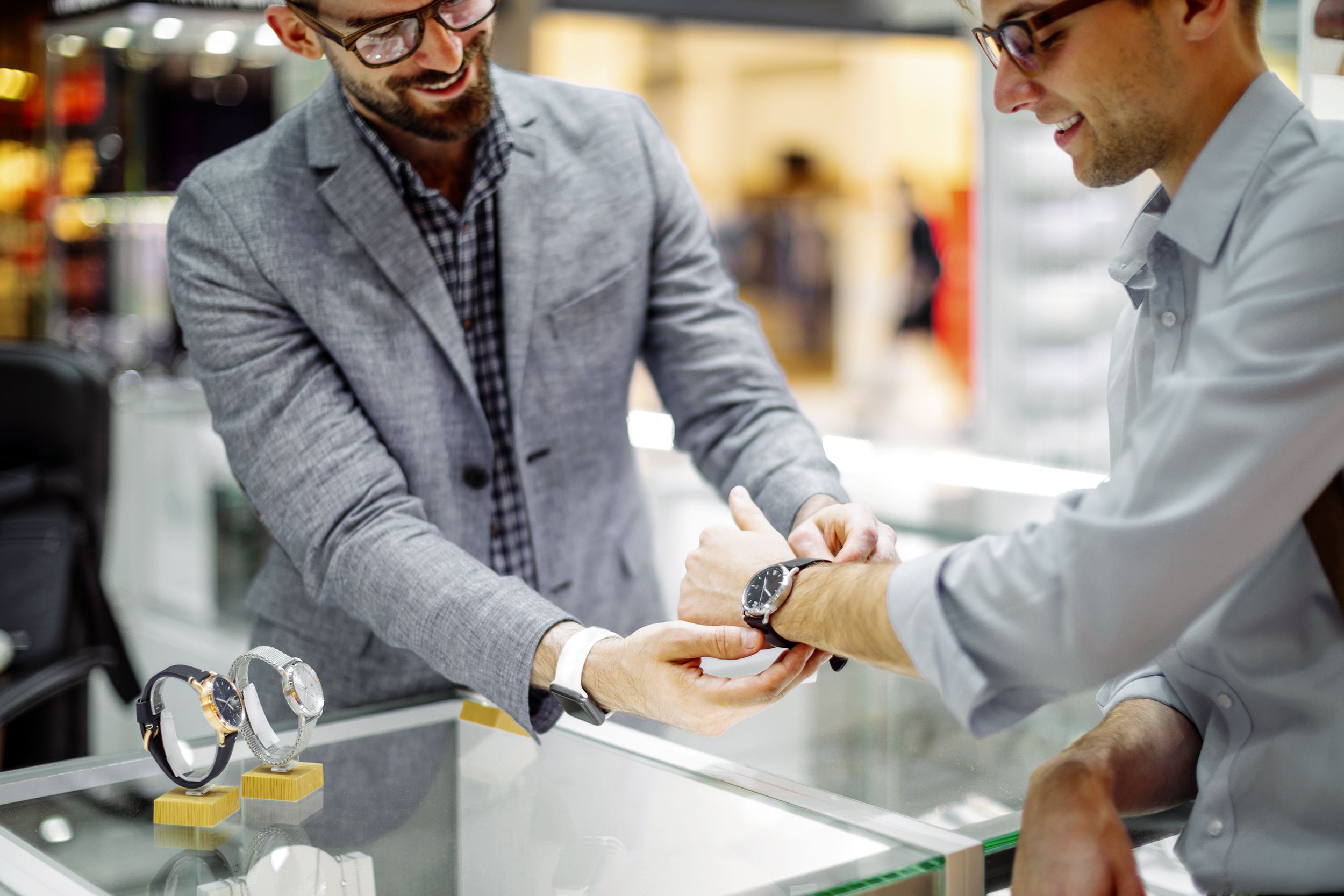 young man is shopping for a watch