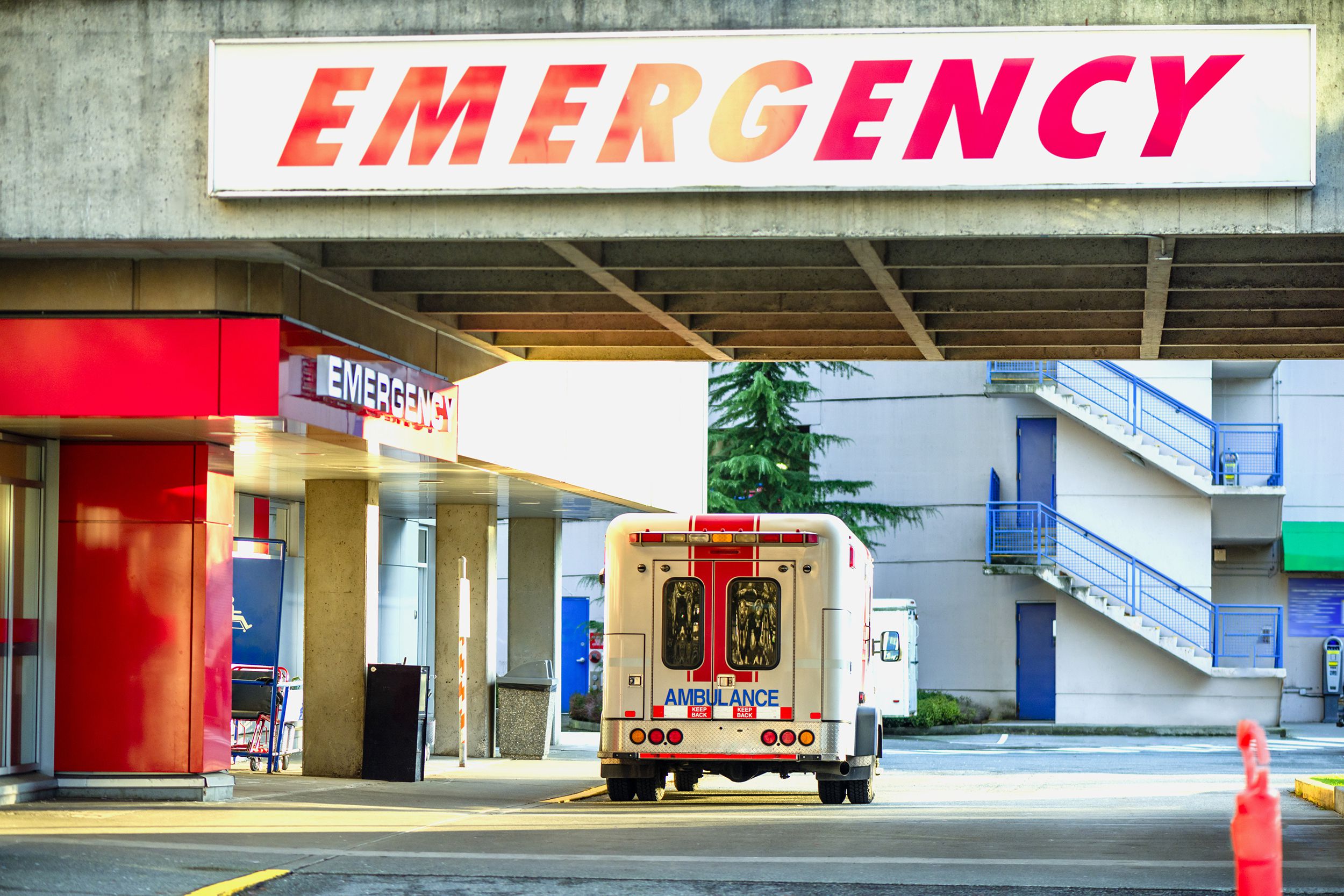 ambulance parked near the emergency entrance to the hospital