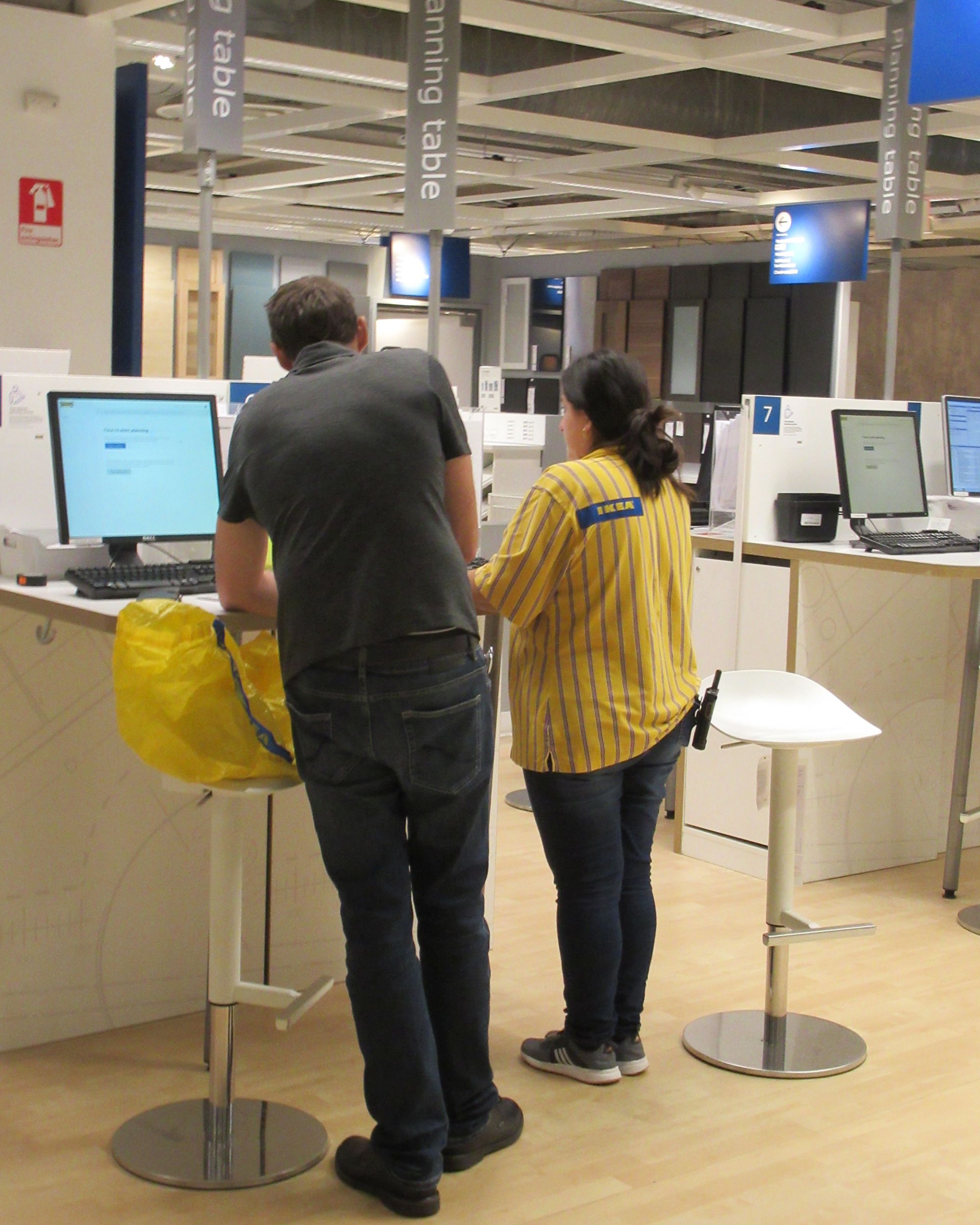 coworker helping customer at kiosk in Ikea