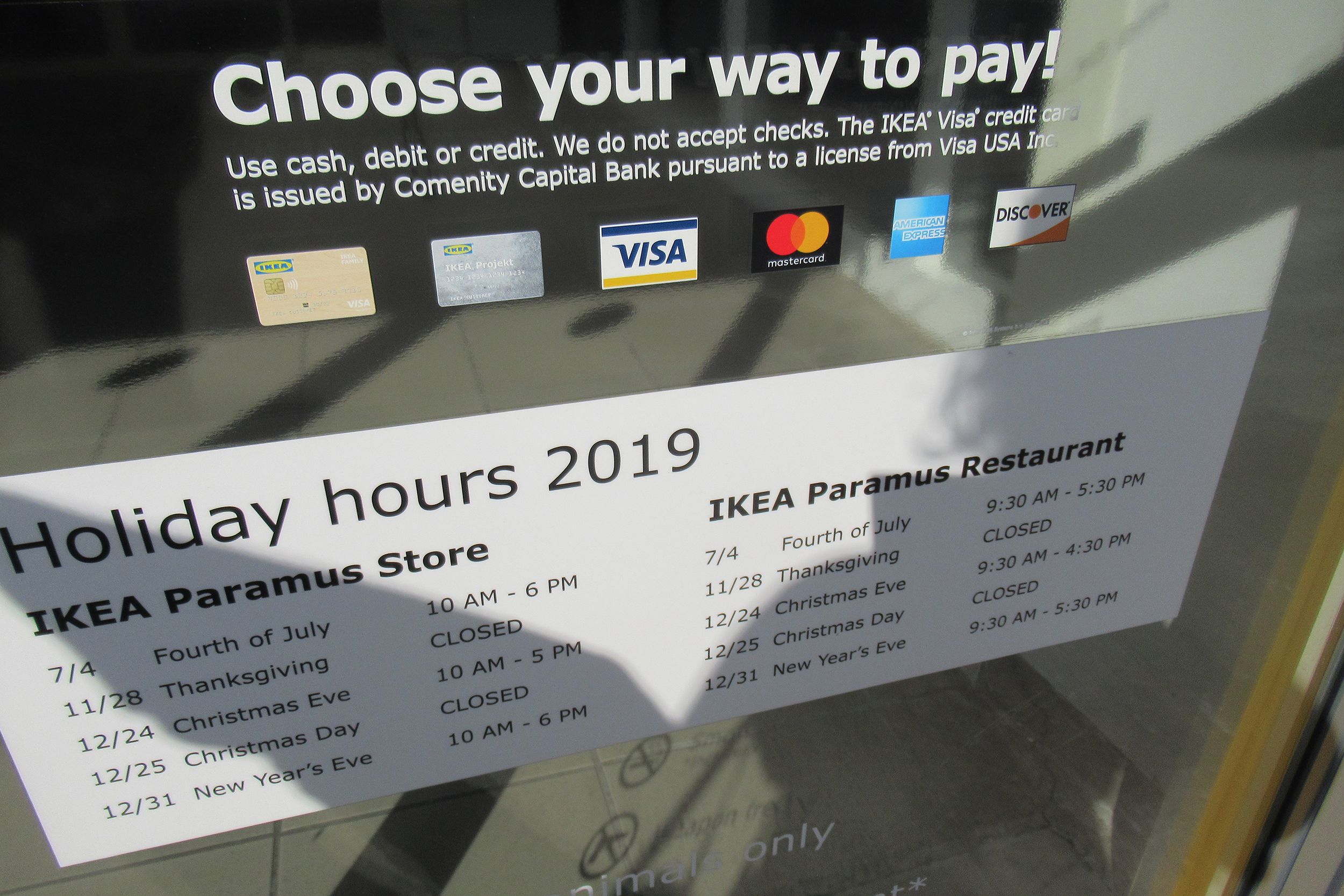front door of Ikea with hours, information