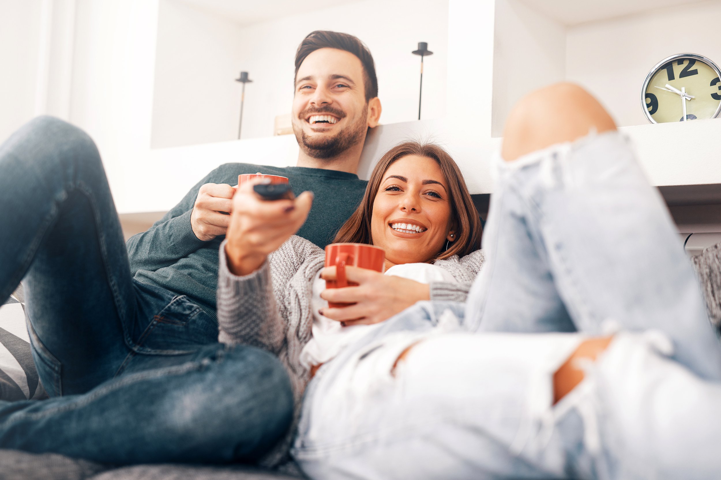 Couple sitting on the couch watching tv