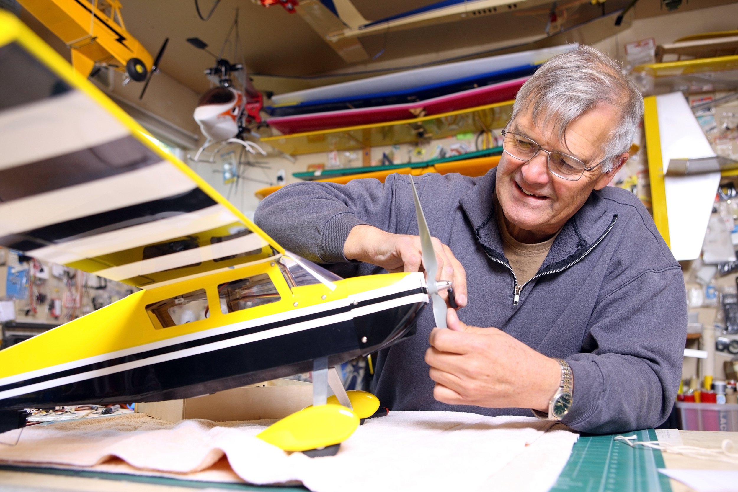 Senior man working on a model airplane