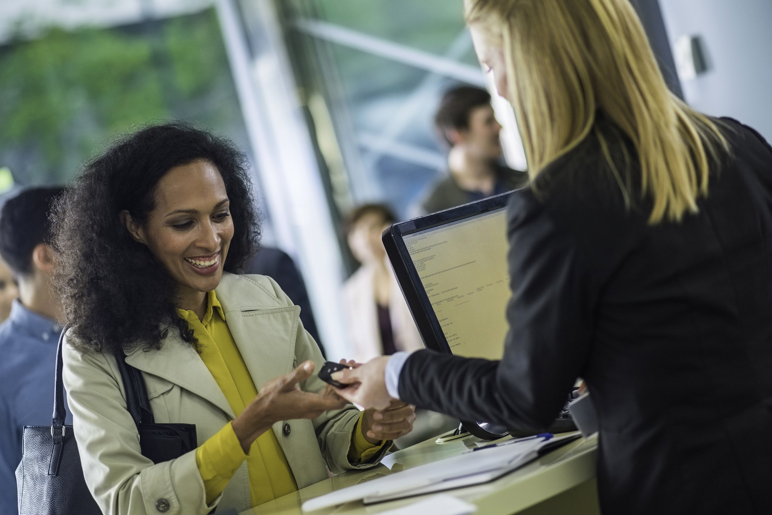 car rental employee giving keys to customer