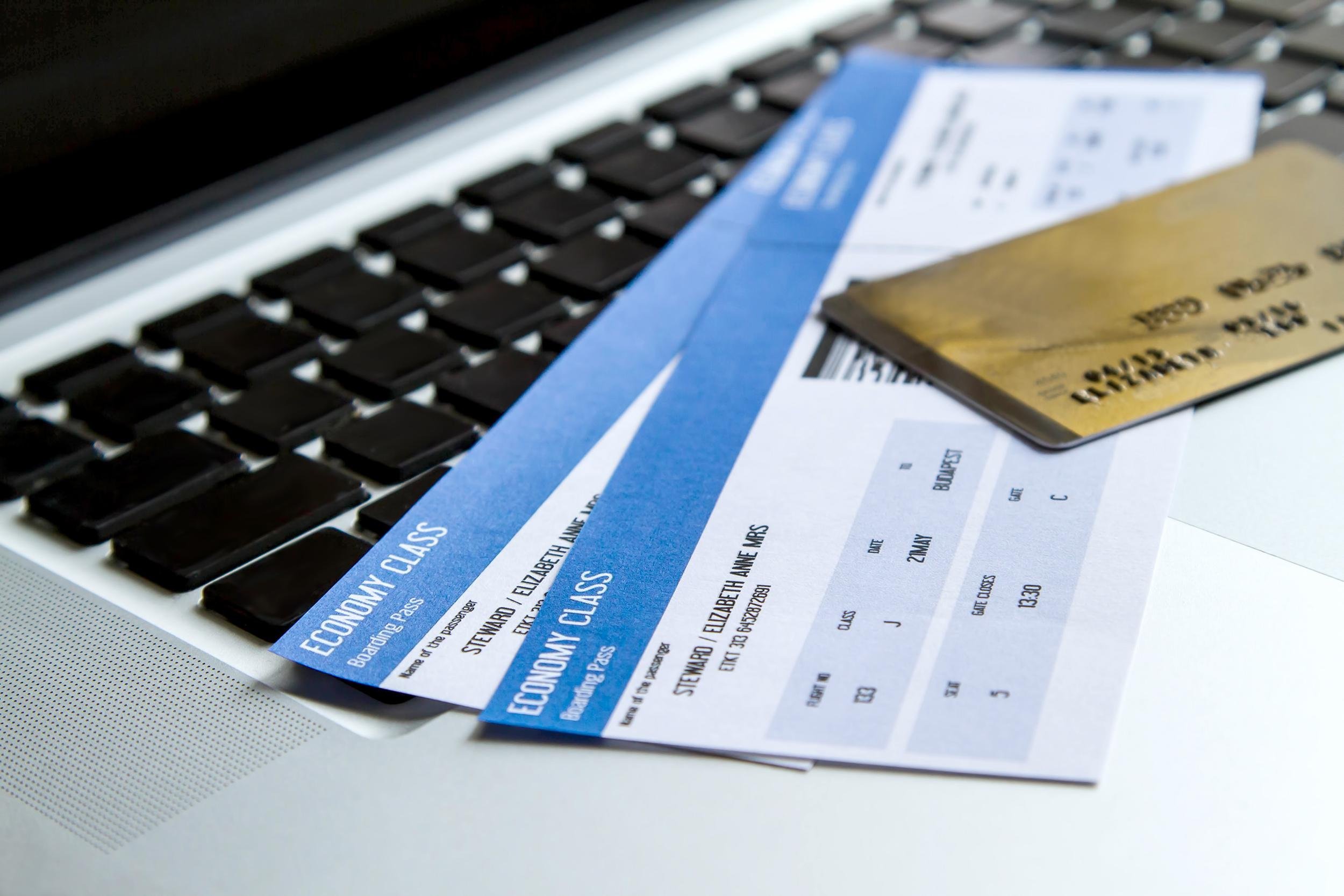 airline tickets on laptop with a credit card