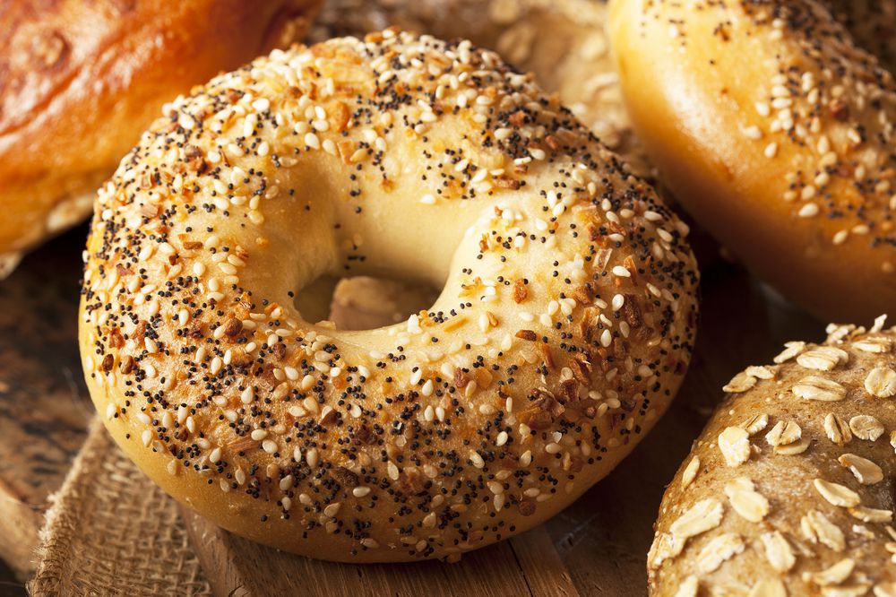 Focus on an Everything Bagel, Surrounded By Three Other Bagels