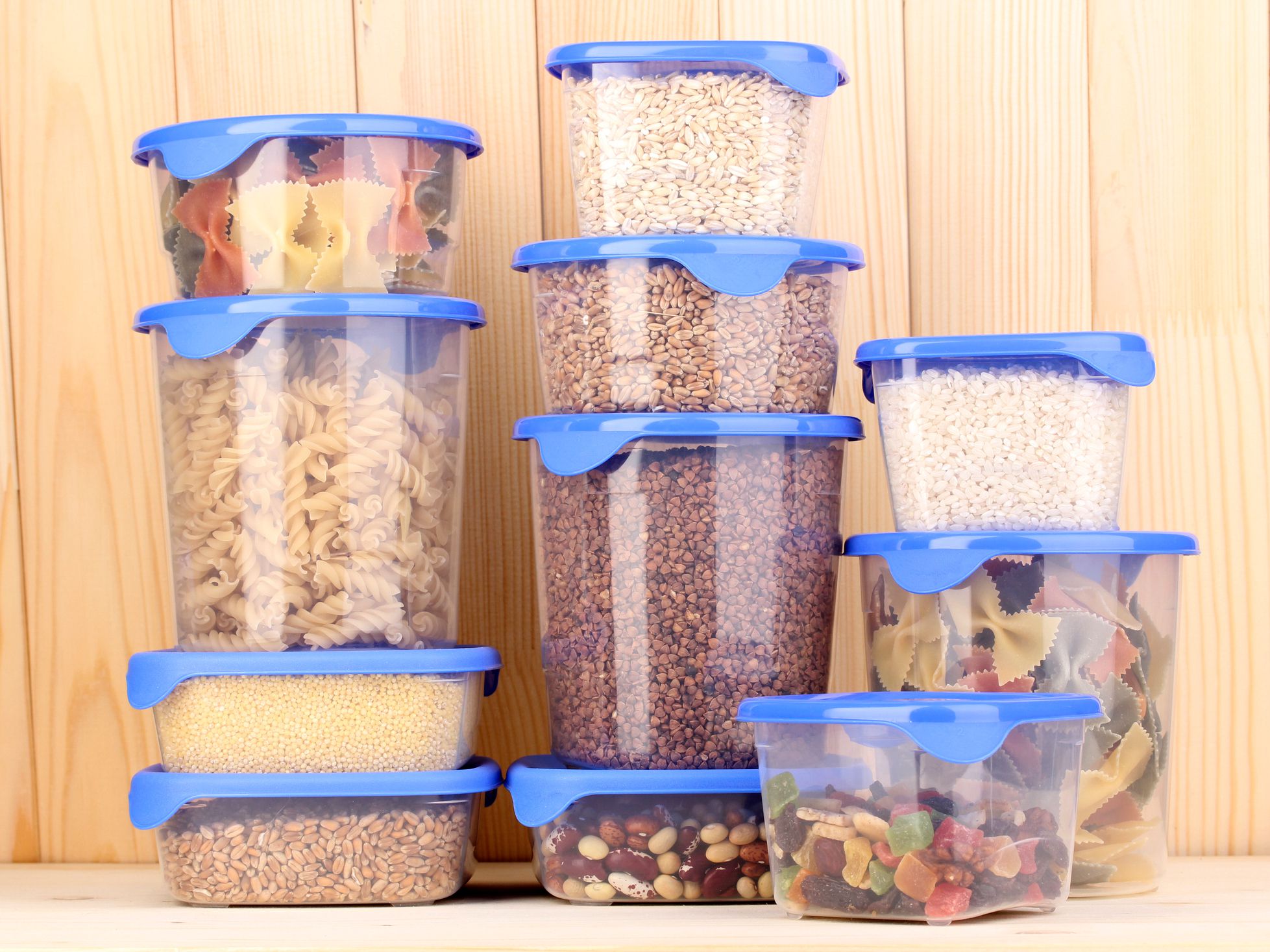 Filled plastic container on wooden background Filled plastic container on wooden background