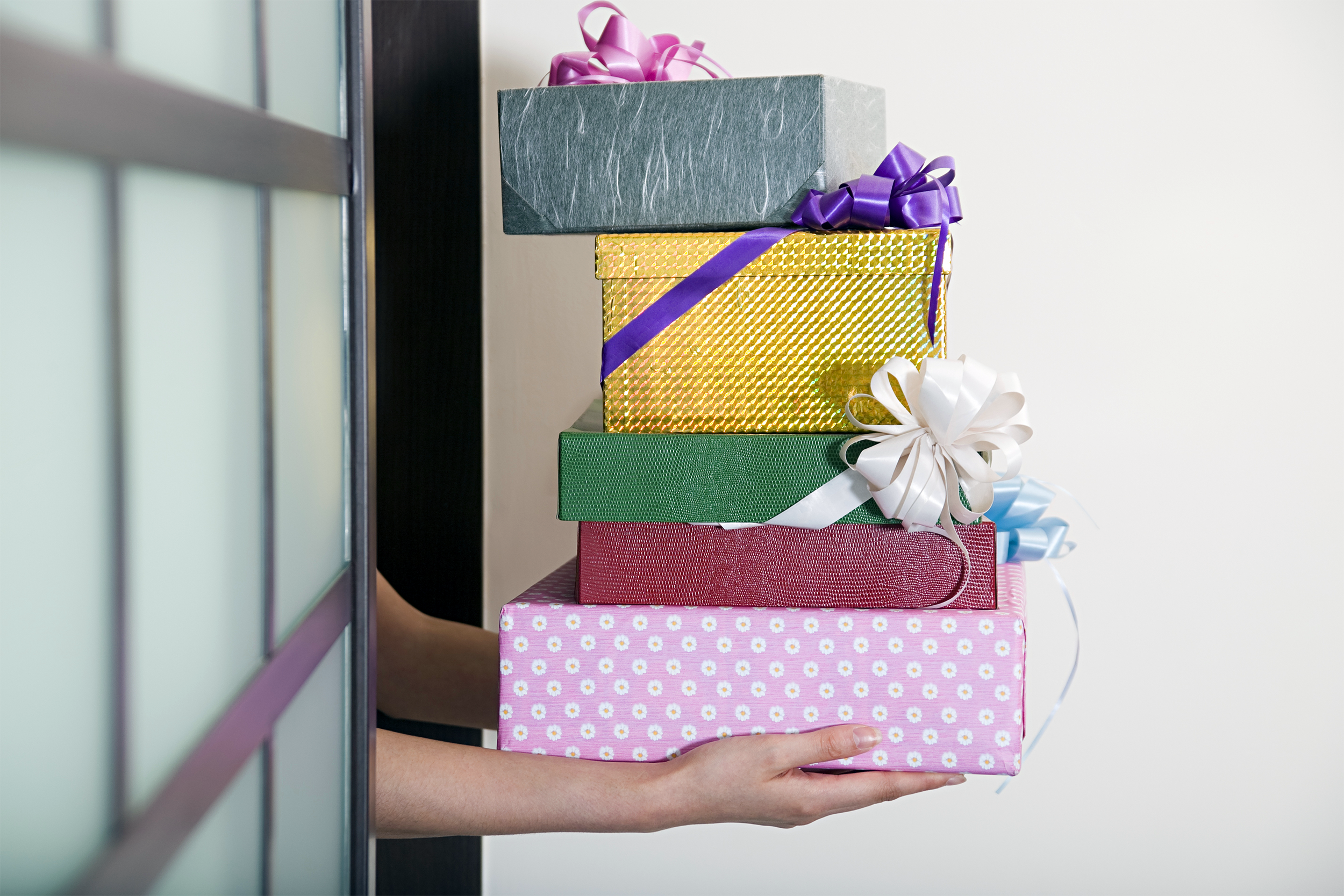 Holding a stack of presents
