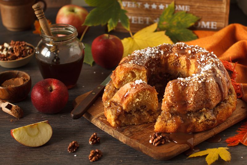 Homemade, rustic apple bundt cake on autumn decoration table