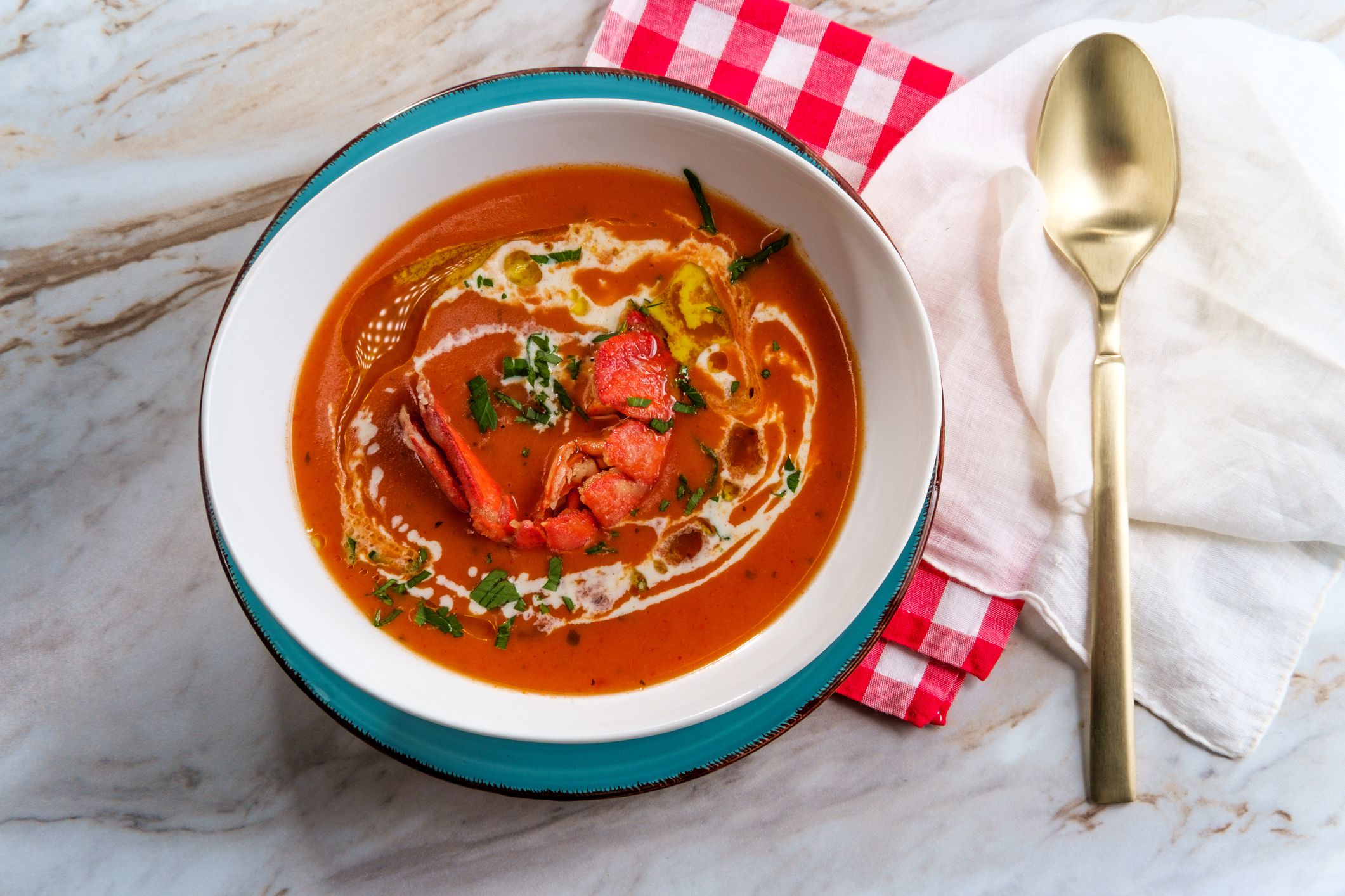 Fresh hot lobster bisque French soup with heavy cream and olive oil drizzle