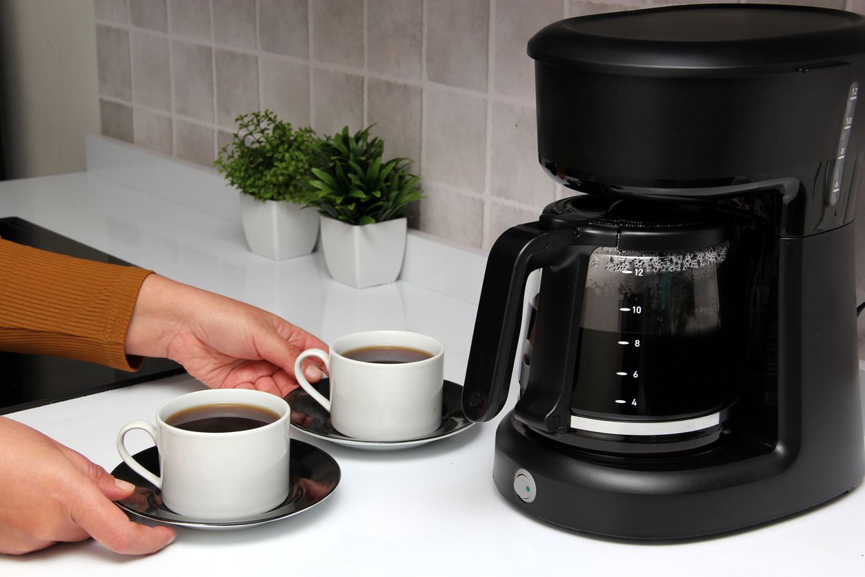 An image of a coffee machine on a nice countertop.