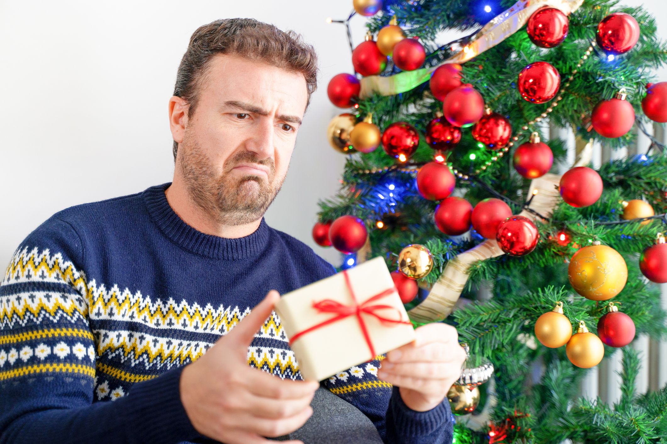 Man feeling angry and disappointed about wrong christmas gift