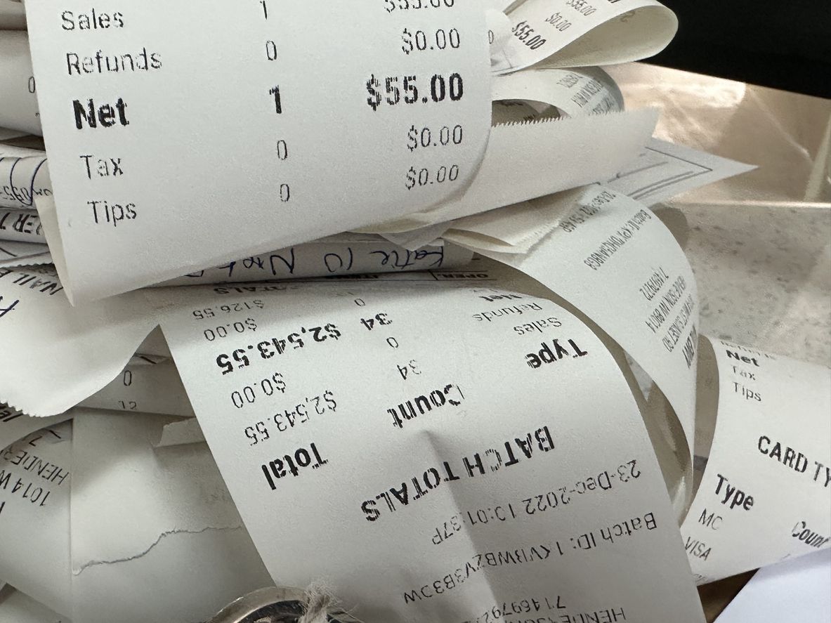 A close-up image of a ton of receipts.