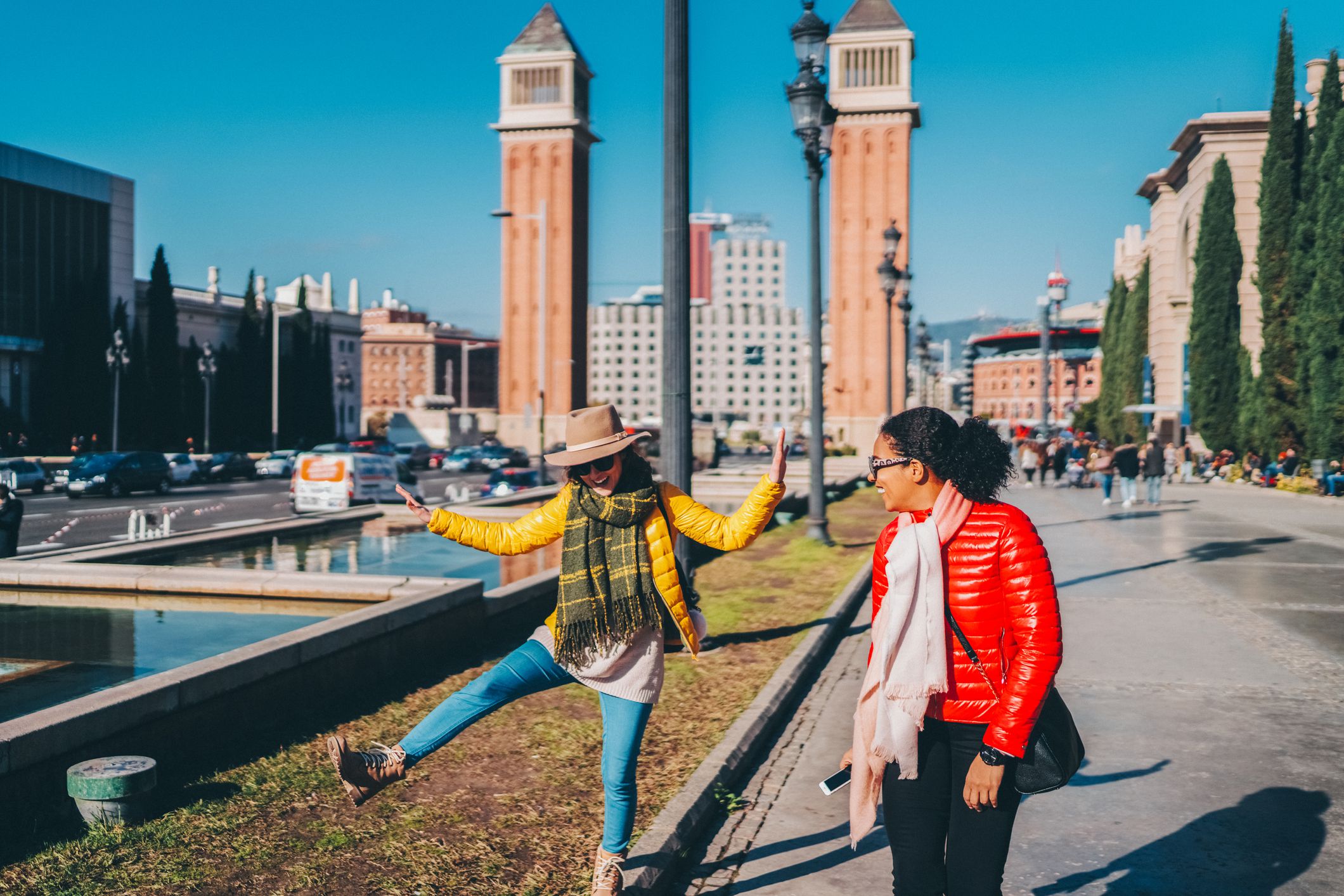 Two women enjoying trip in Barcelona during winter season, December before Christmas