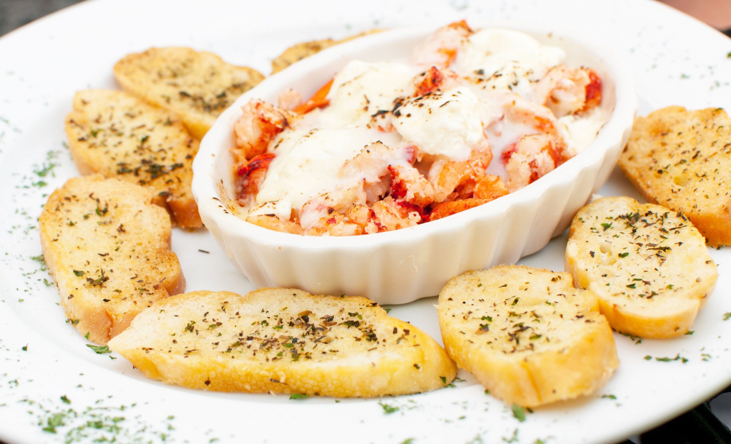 Lobster meat with cheese casserole and grilled bread