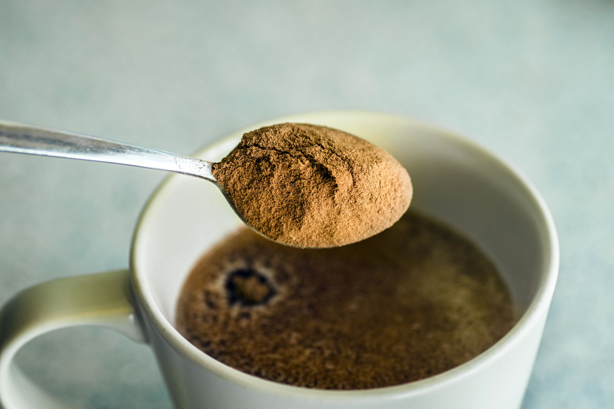 hot cocoa mix in spoon in mug