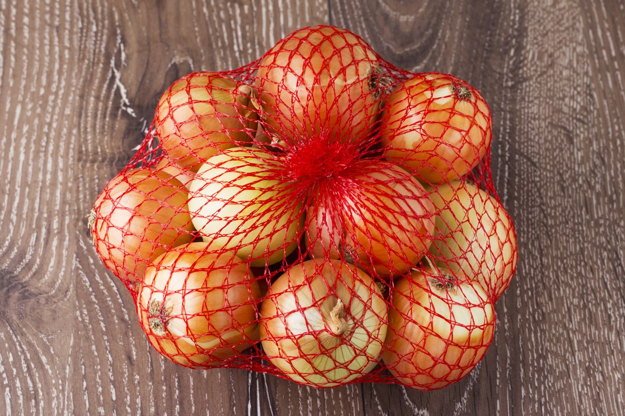 A mesh bag filled with onions.
