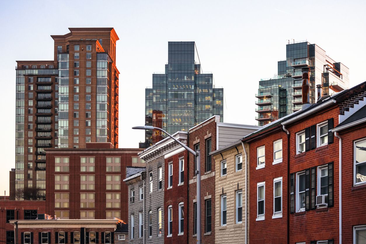 A few high-rise apartment buildings in a nice city neighborhood.