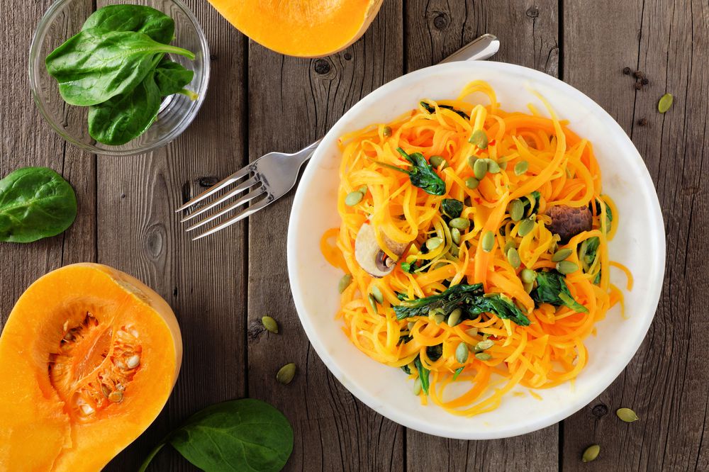 Healthy butternut squash spirilized noodle dish, above scene on wood