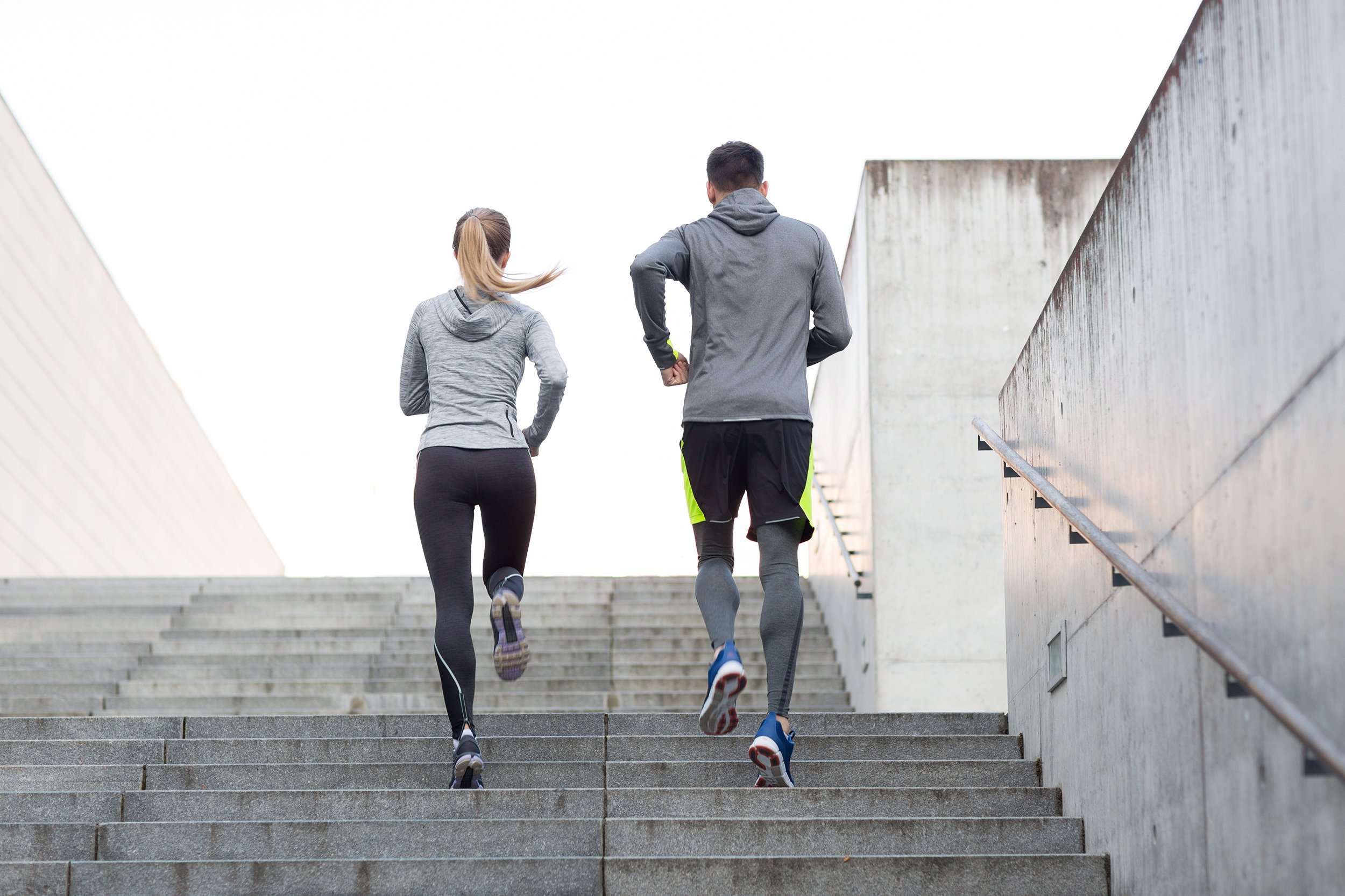 couple running upstairs on city stairs