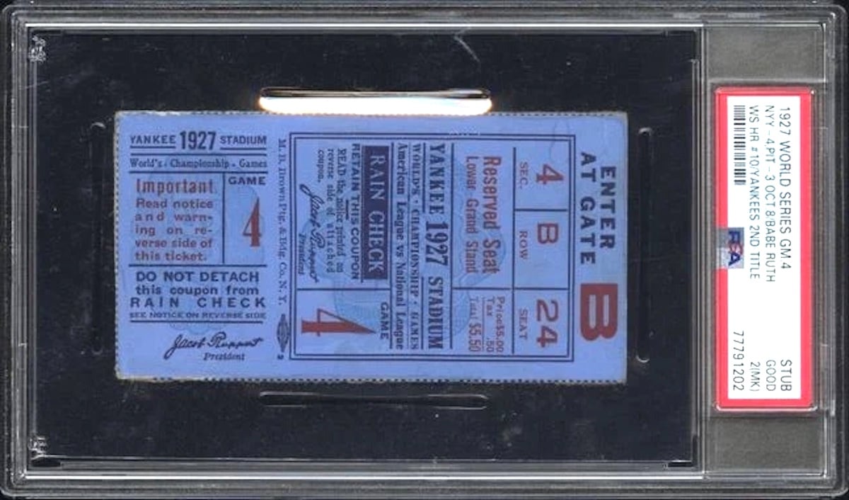 A vintage 1927 World Series Game 4 ticket stub for Yankee Stadium, one of the most expensive collectibles, is encased in a protective PSA slab. The blue ticket displays black and red text with section, row, seat, and rain check details.