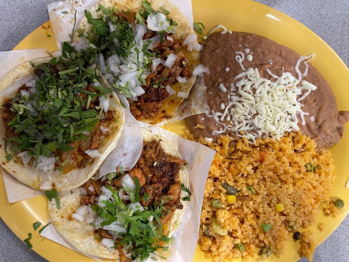 Al Pastor Taco Dinner on a yellow plate, Taqueria Los Comales, Chicago, on a table at the restaurant