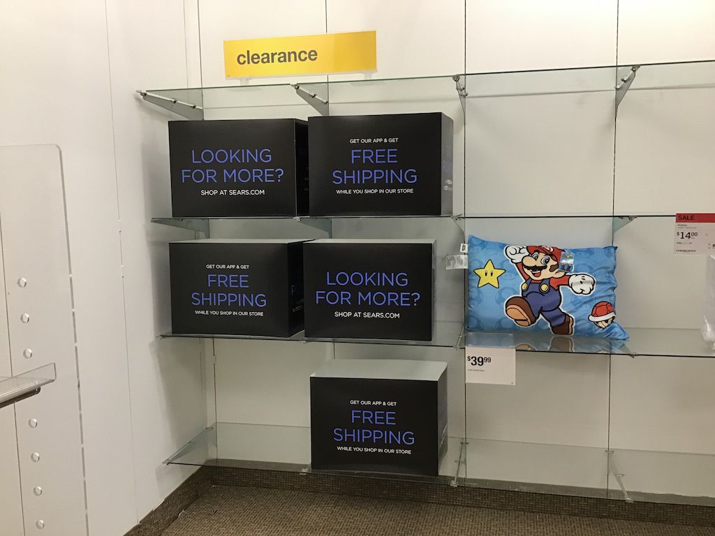 Empty shelves with one Mario Kart pillow case at Brunswick Sears