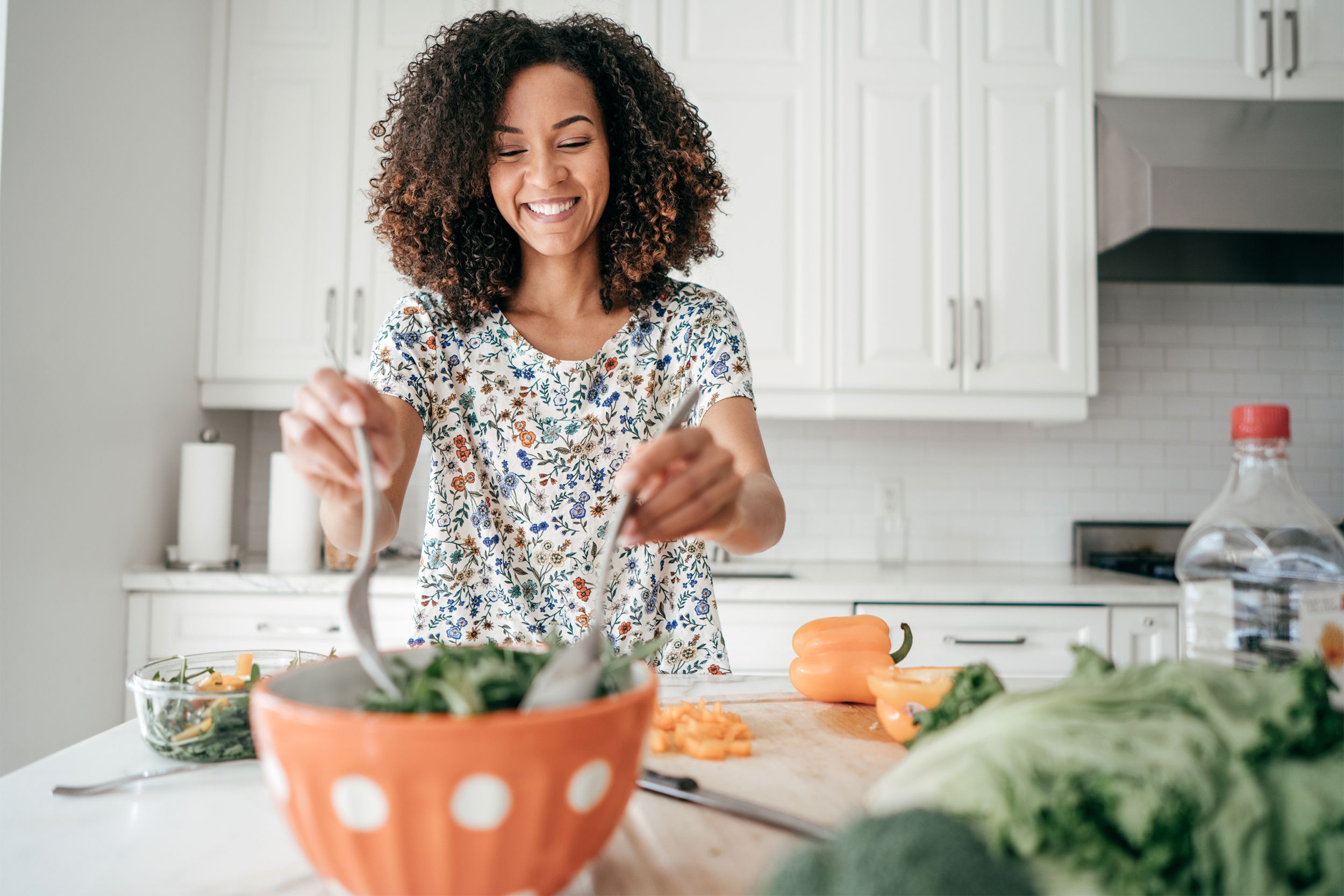 Woman preparing a salad in her kitchen