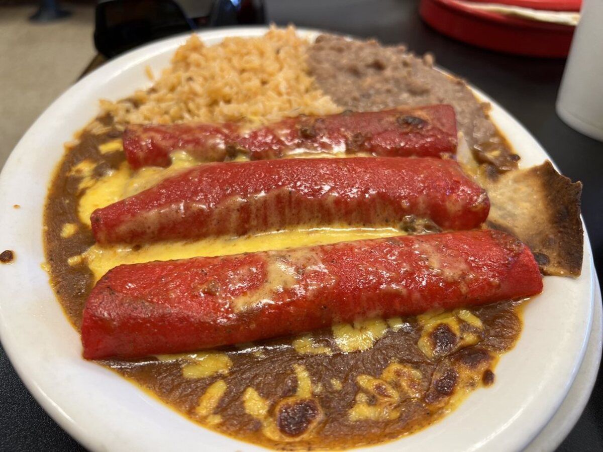 Closeup of Deluxe Plate on a white plate wit three striking red tortillas, Blanco Cafe, San Antonio, blurred background of table and restaurant