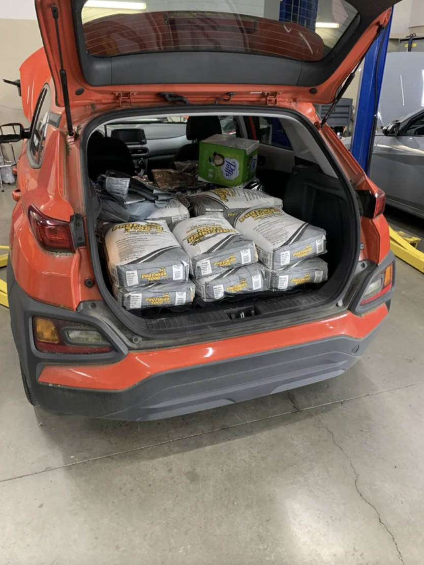 An image of a car that has 800 pounds of concrete loaded into the back of it.