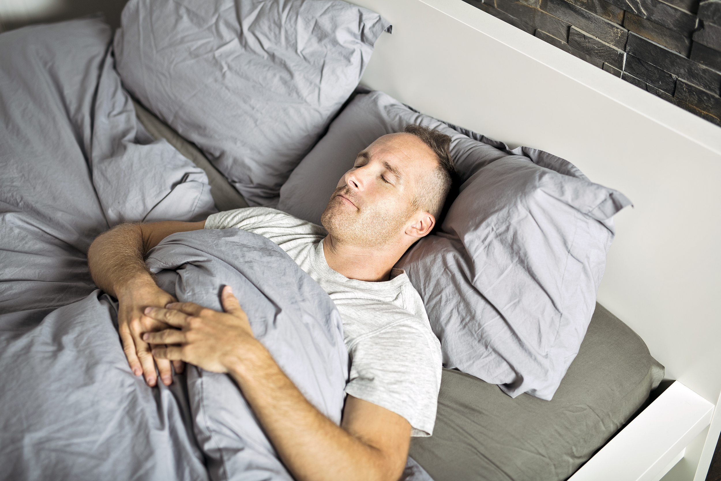 Man sleeping on his back