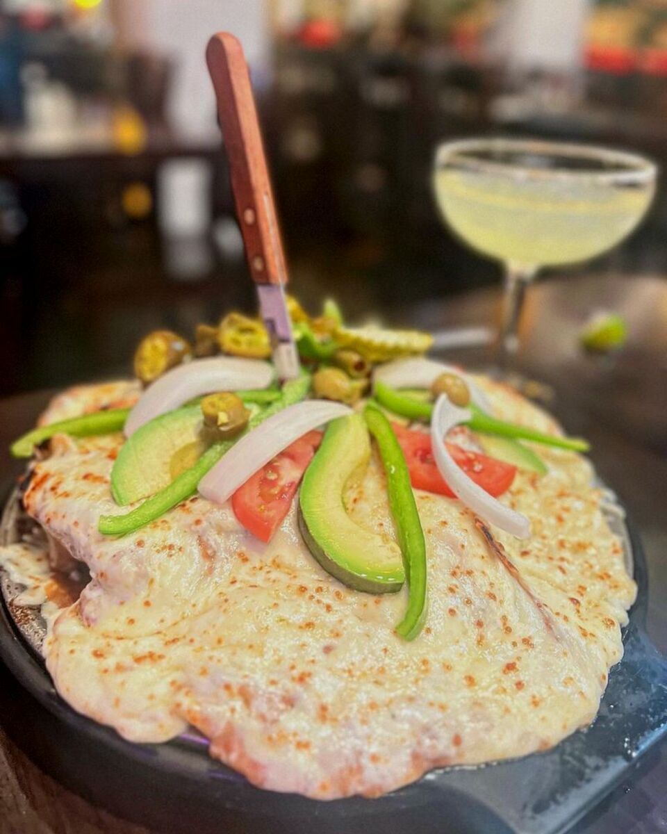 Super Nachos on a Metal Server with Knife in the Middle, Mexican Village, Detroit, a Margarita on the right, at the bar in the restaurant, blurred