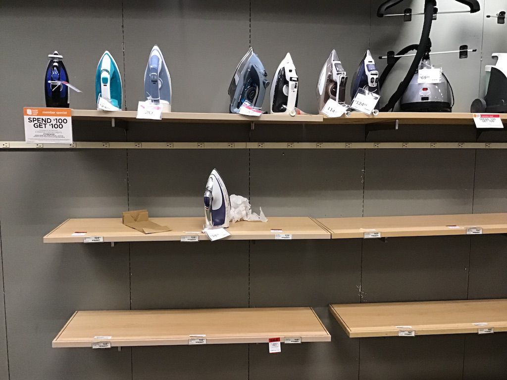 Almost empty shelves with a few irons and some trash at White Oak Sears