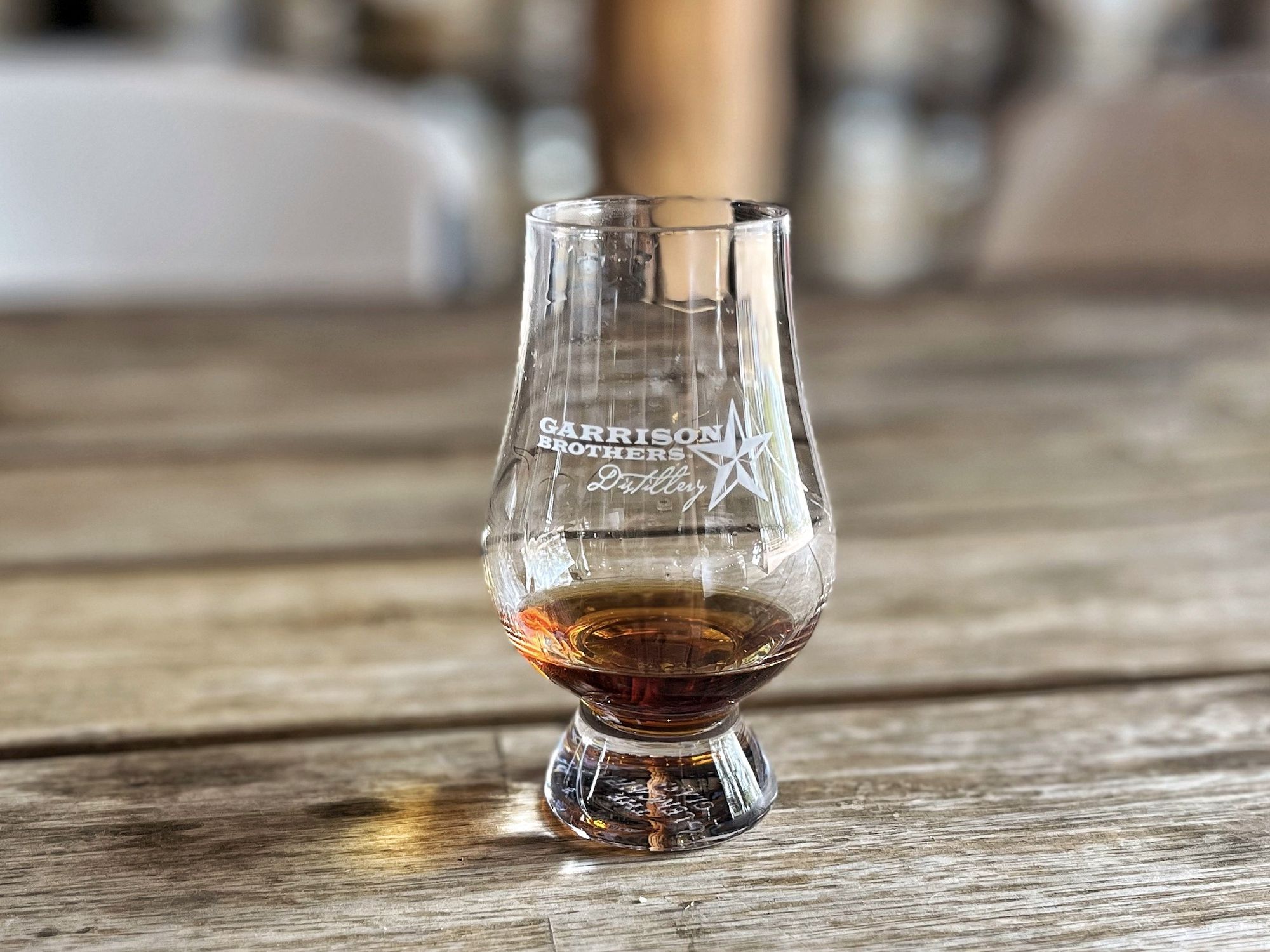 a glass of garrison brothers whiskey at the distillery in hye, texas
