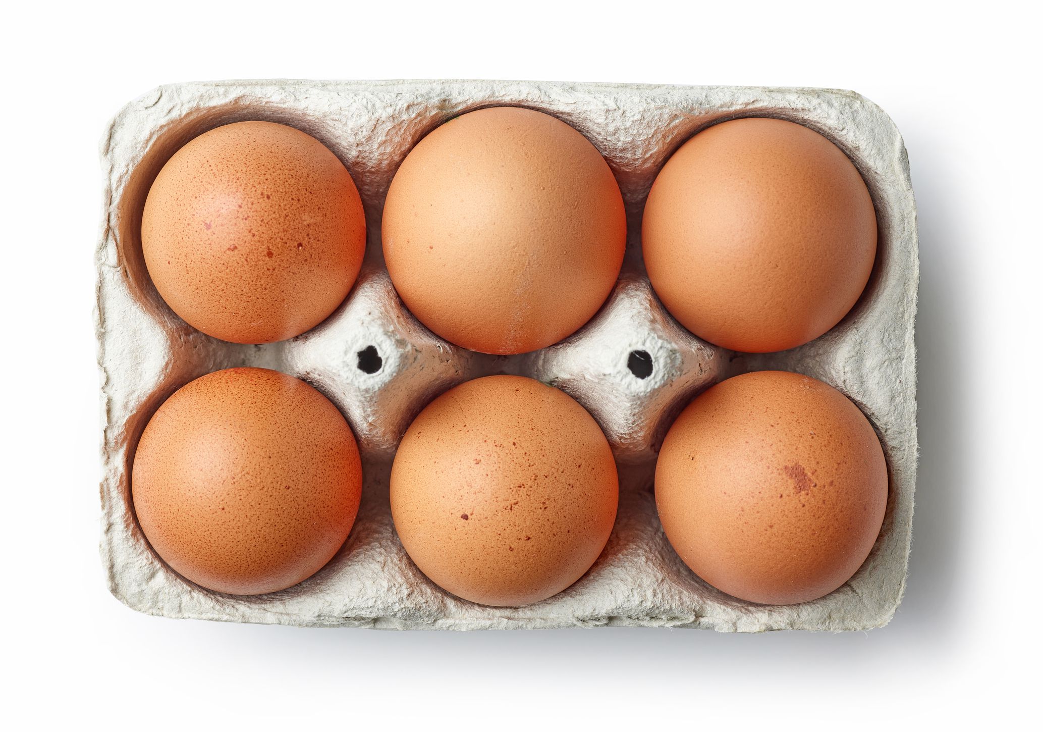 brown chicken eggs in egg box isolated on white background, top view