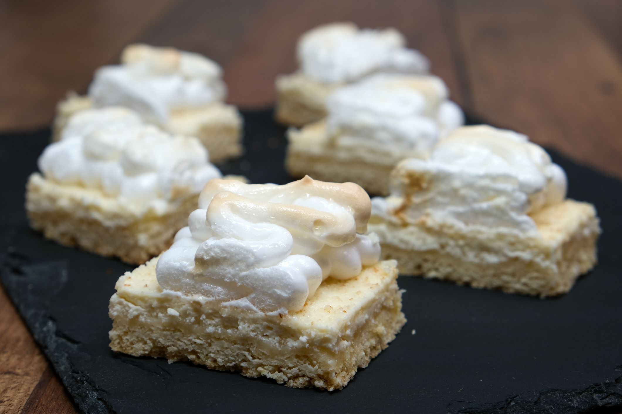 Cake with whipped cream on wooden table
