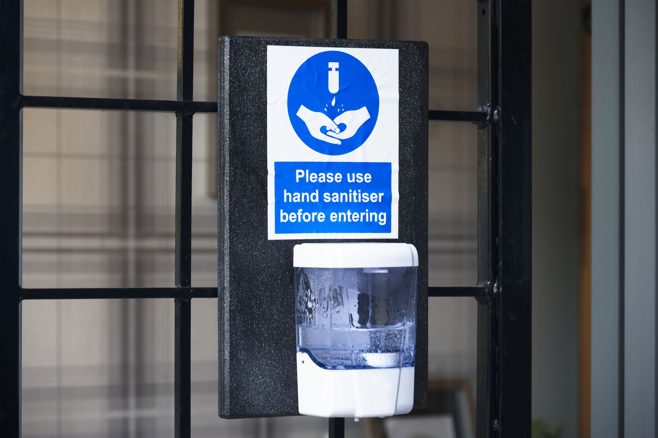 Hand sanitiser dispenser for customer use to wash hands reduce risk of coronavirus virus with liquid sanitizer soap dispenser sign uk