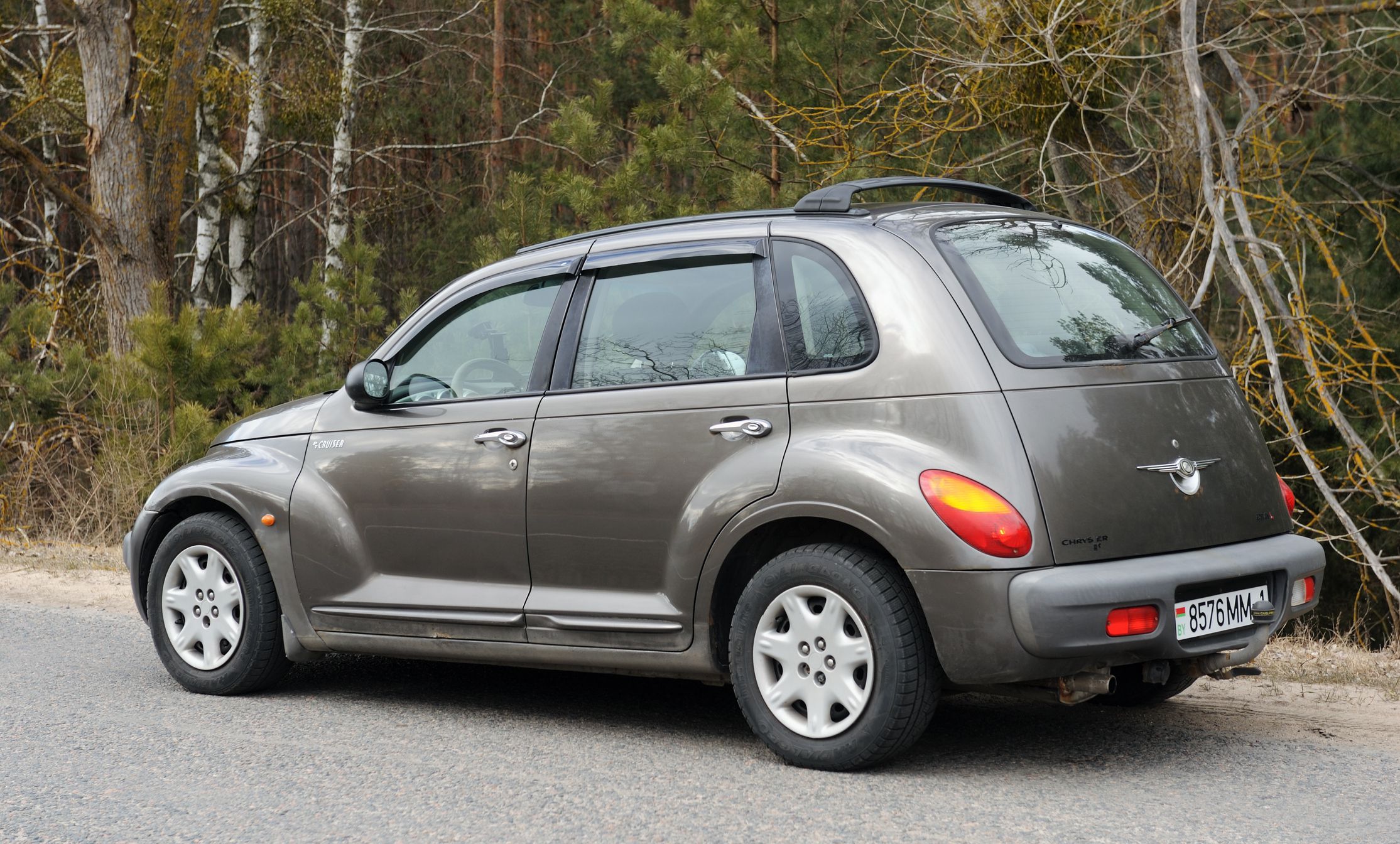 Belarus, Minsk-13.03.2022:Chrysler PT Cruiser car parked on the road in the forest.