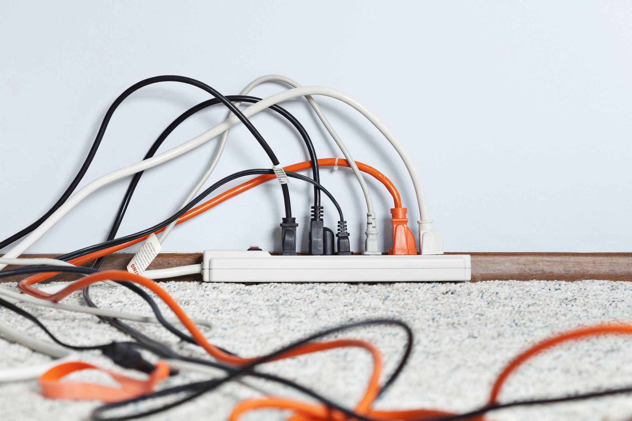 Power strip full of electrical power cables.