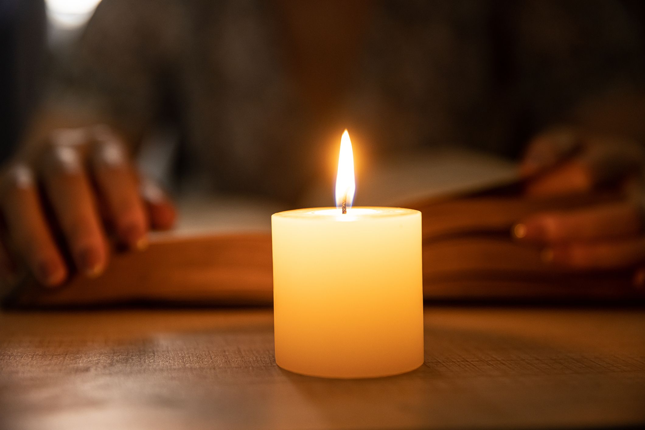 Reading a book by candle at night