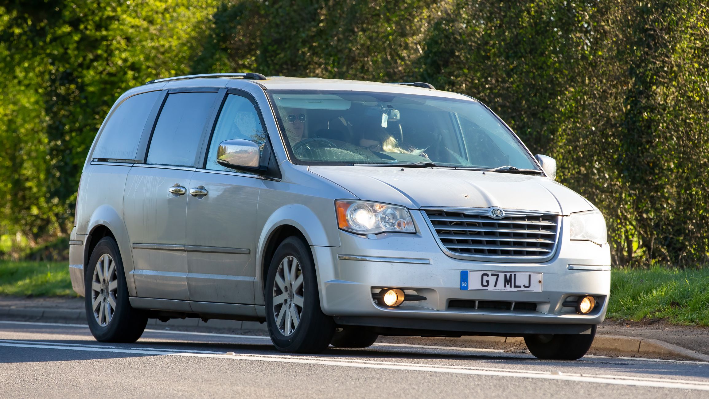 Bicester,Oxon, UK - April 7th 2023. 2011 silver CHRYSLER GRAND VOYAGER car travelling on an English country road