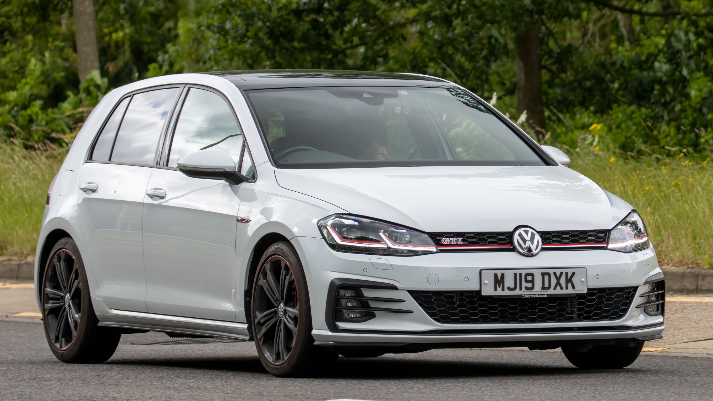 Milton Keynes,UK - July 2nd 2023. 2019 white VOLKSWAGEN GOLF GTI PERFORMANCE TSI car travelling on an English country road
