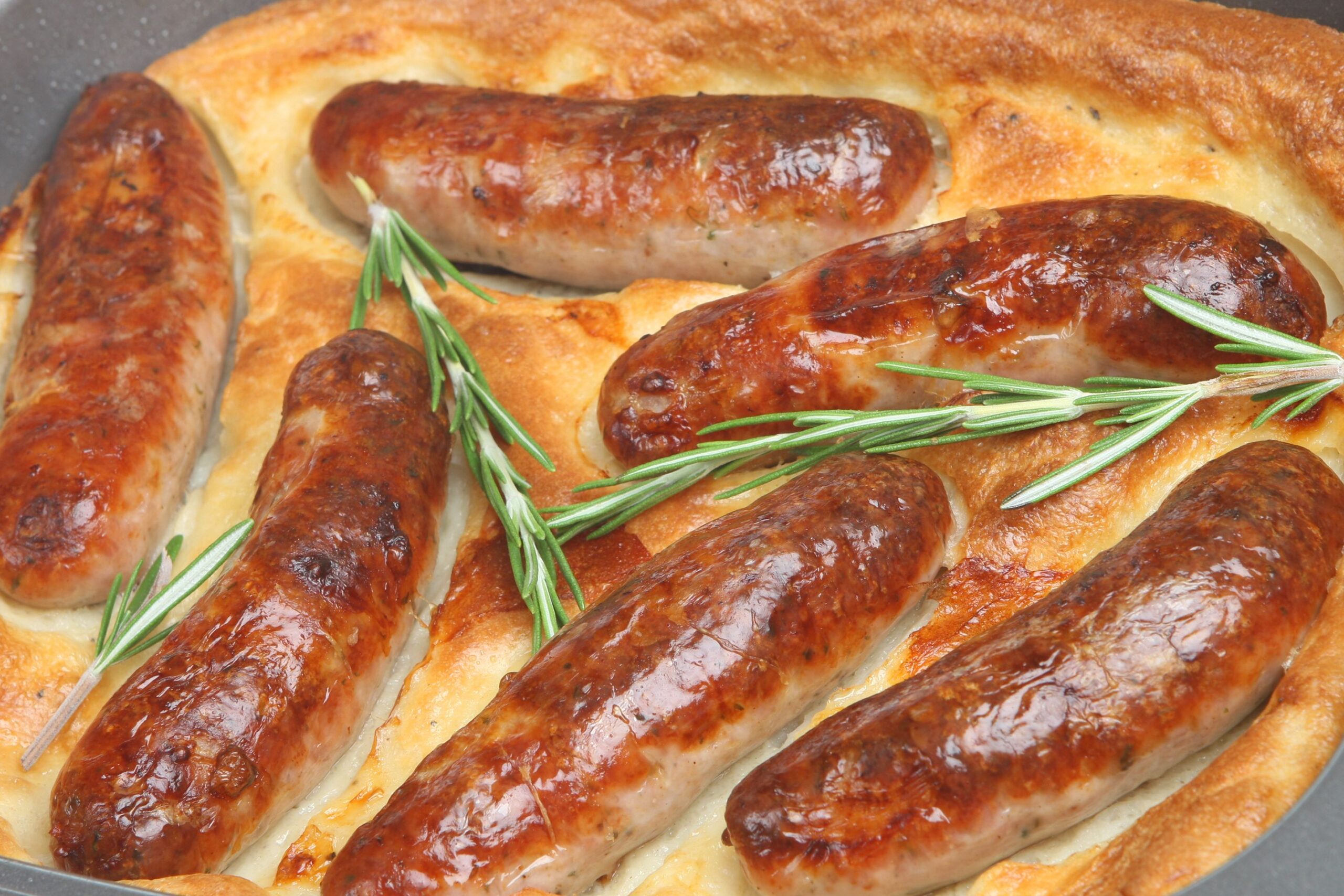 Traditional British dish of sausages baked in Yorkshire pudding batter